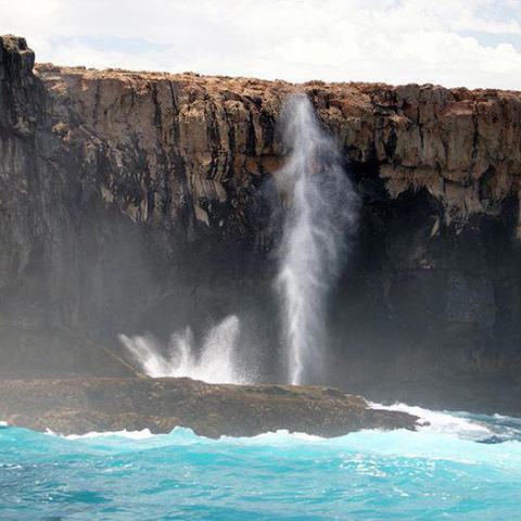 a large waterfall over some water