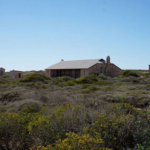 a house on a grassy hill