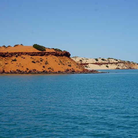 a large body of water with a mountain in the ocean